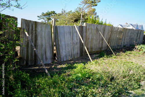 Falling down and damaged wooden fence