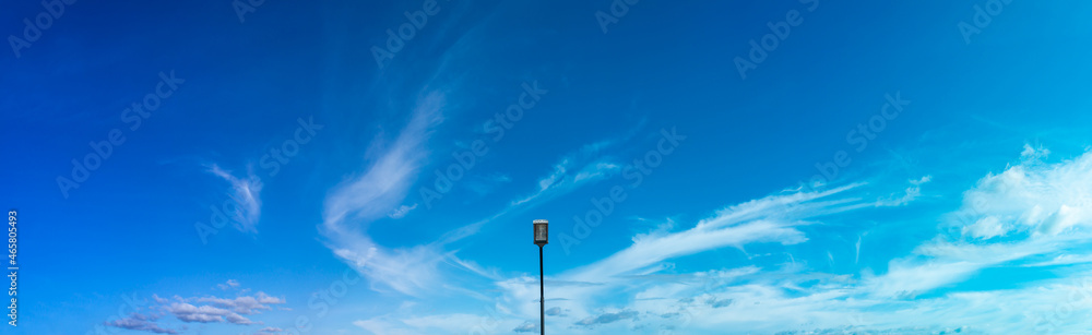 An electric pole stood in the middle of the blue sky. - obrazy, fototapety, plakaty 