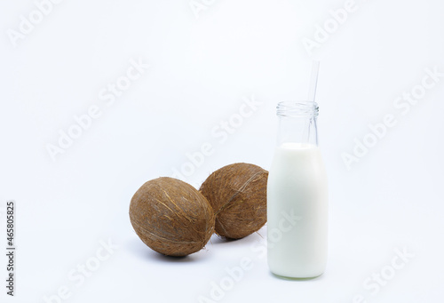 Bottle of coconut milk фтв Сoconut nuts a white background healthy life concept	