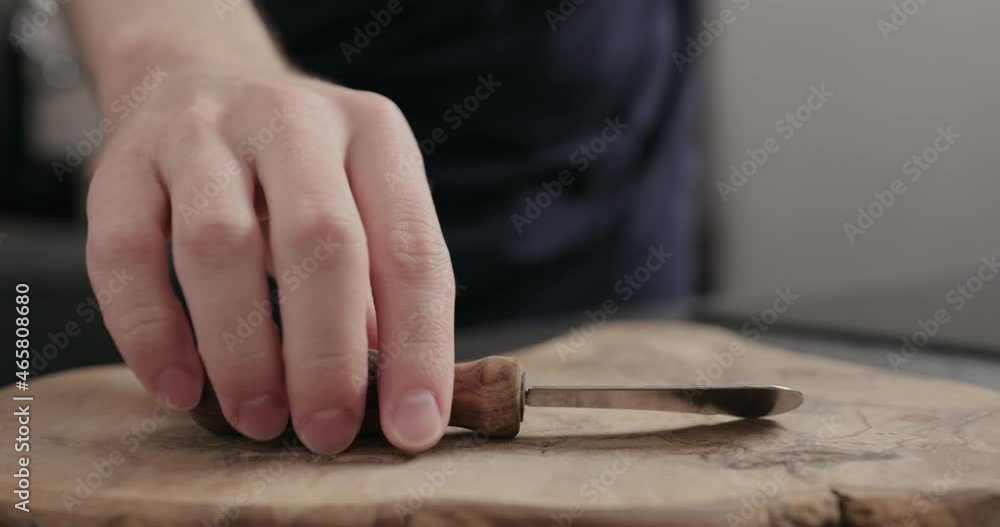 Slow motion man hand put slice of white loaf bread on olive wood board Slow motion man hand put slice of white loaf bread on olive wood board