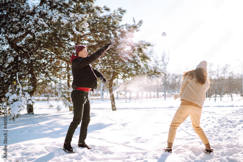 Love story young couple in winter. Happy couple walking and having fun at nature. Holidays, season, love and leisure concept. Love story young couple in winter. Happy couple walking and having fun at nature. Holidays, season, love and leisure concept.
