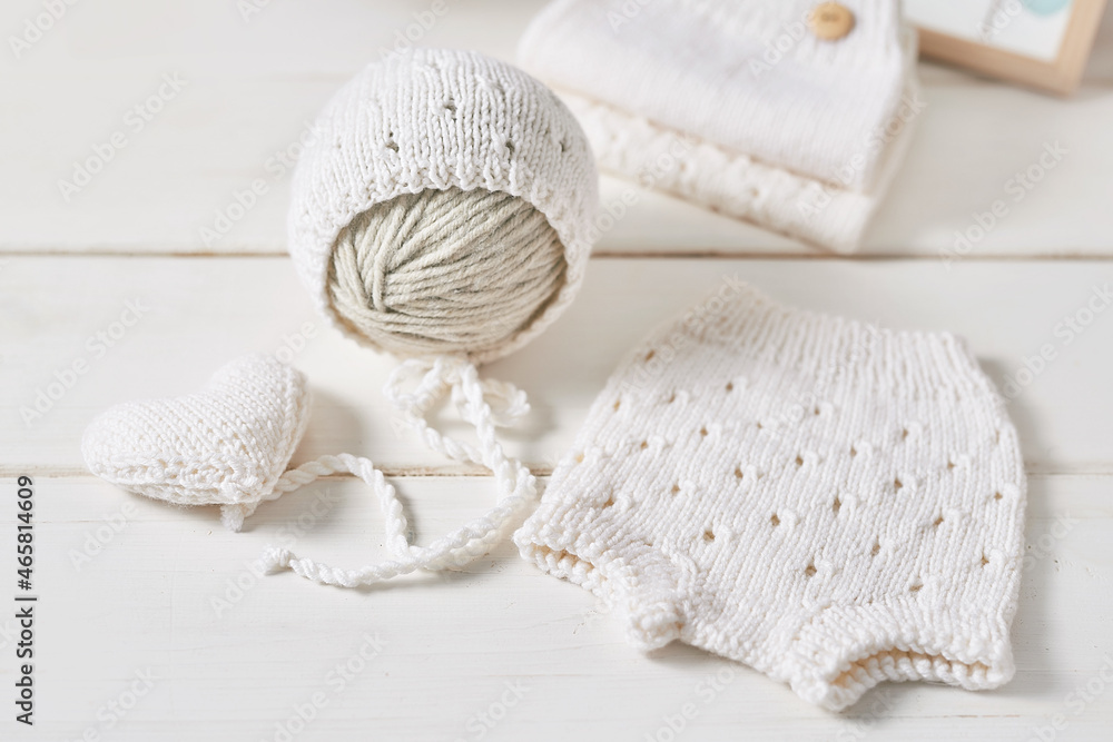 Obraz premium Knitted kids clothes and accessories for knitting. Needlework and knitting. Hobbies and creativity. Knit for children. Handmade