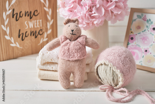 Knitted kids clothes and accessories for knitting. Needlework and knitting. Hobbies and creativity. Knit for children. Handmade. Knitted toys rabbit. Handmade toy hare.