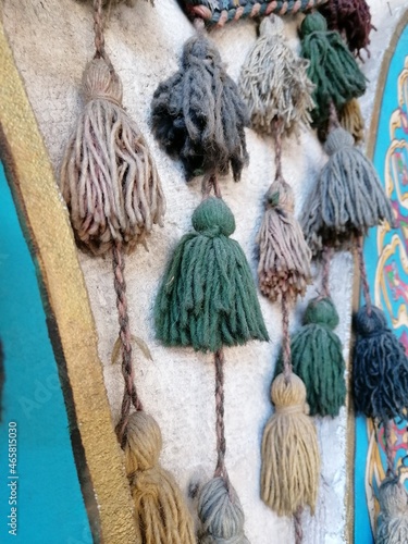 tassels hanging from a wall in colour