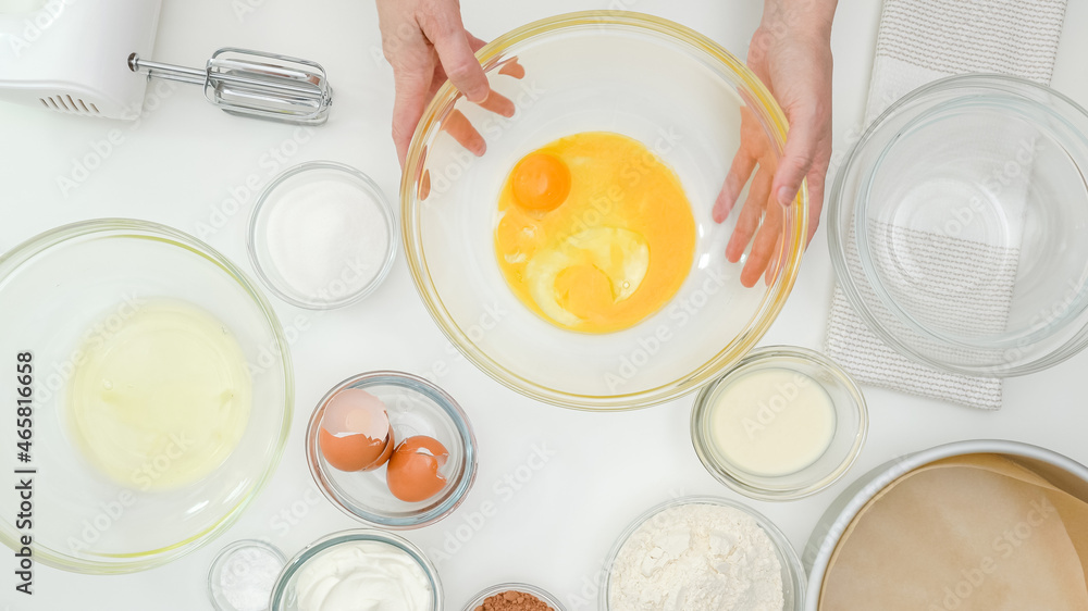 Egg yolks, egg whites, flour, sugar, and some ingredients for cake recipe close up on kitchen table. Homemade chocolate cake step by step baking process Egg yolks, egg whites, flour, sugar, and some ingredients for cake recipe close up on kitchen table. Homemade chocolate cake step by step baking process