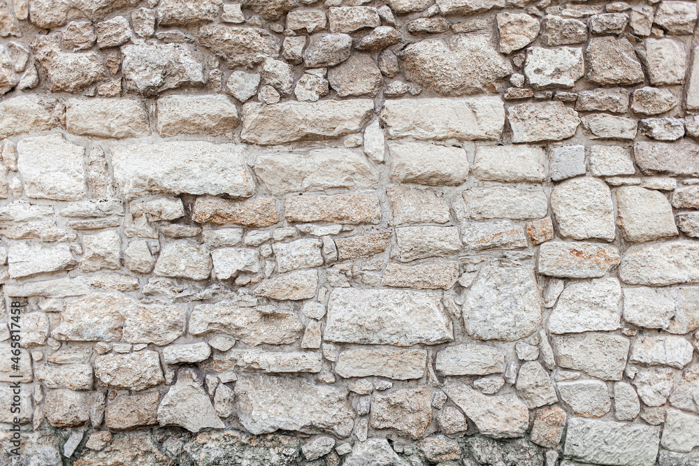 Beige rough stone rock wall