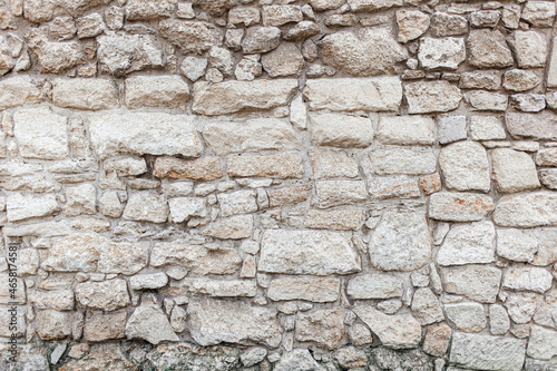 Beige rough stone rock wall