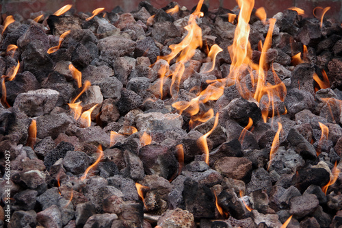 Flames over lava stones