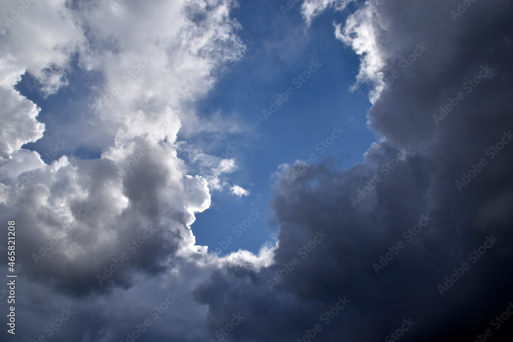 Blue and white cumulus storm clouds thunderstorm landscape