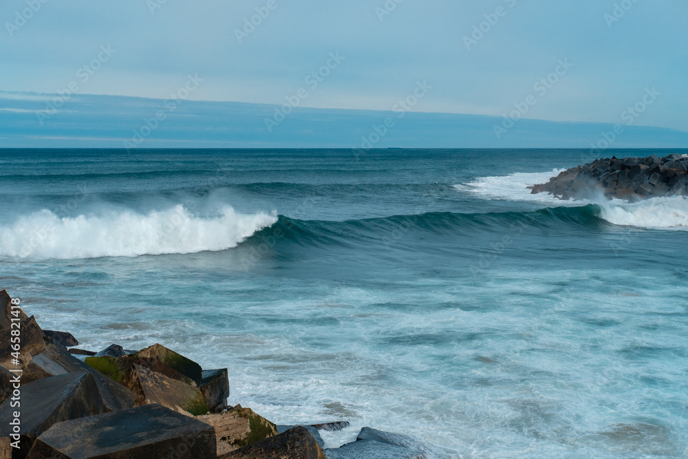 Sea waves and rocks. Seasore. Basque country landscape. Rainy weather. Blue water and sky. Sea waves and rocks. Seasore. Basque country landscape. Rainy weather. Blue water and sky.