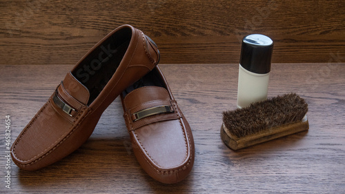 Canvastavla BROWN MOCCASIN SHOES, ON WOODEN FLOOR WITH NATURAL LIGHTING AND SPACE FOR TEXT