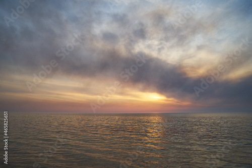 Sea sunset. Smoke wildfires sweeping across the sky.