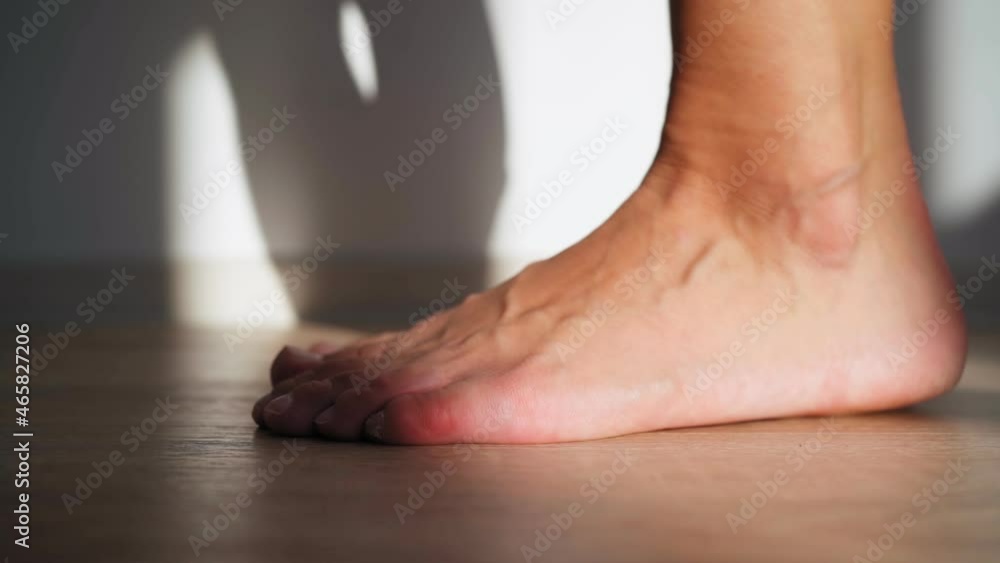 Close up, Beautiful Barefoot Female Feet in Bright Sunlight. Woman Stretches Her Legs. Body Care Concept. Warm Up the Ankles. Close up, Beautiful Barefoot Female Feet in Bright Sunlight. Woman Stretches Her Legs. Body Care Concept. Warm Up the Ankles.