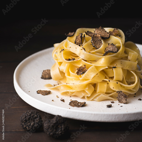 Tagliatelle pasta with black truffle mushrooms. Tagliatelle al tartufo - Italian autumn fresh recipe with black truffle, rustic style, square crop