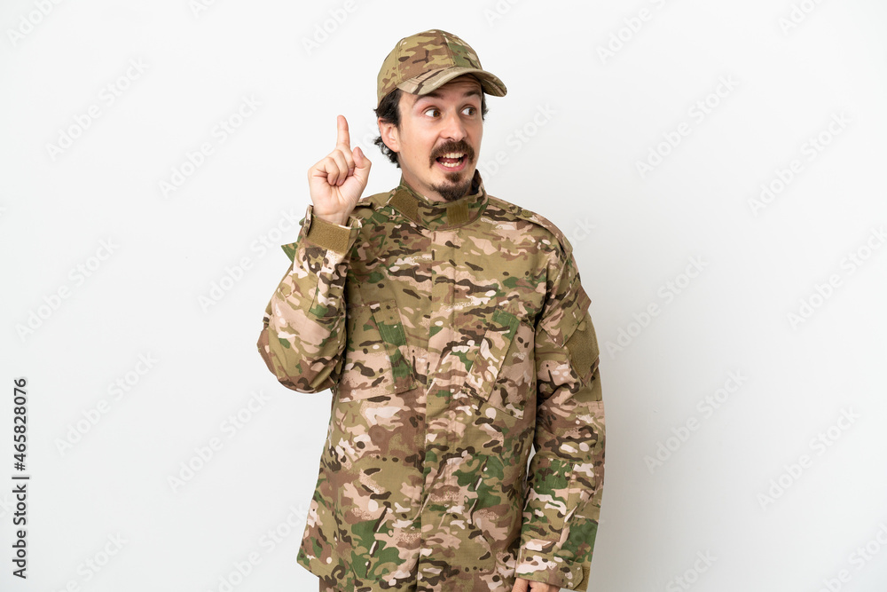 Soldier man isolated on white background intending to realizes the solution while lifting a finger up