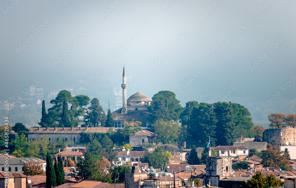 View of the fortified old city of Ioannina, Greece, in a foggy day, with the Alsan Pasha Mosque on top of the hill.
