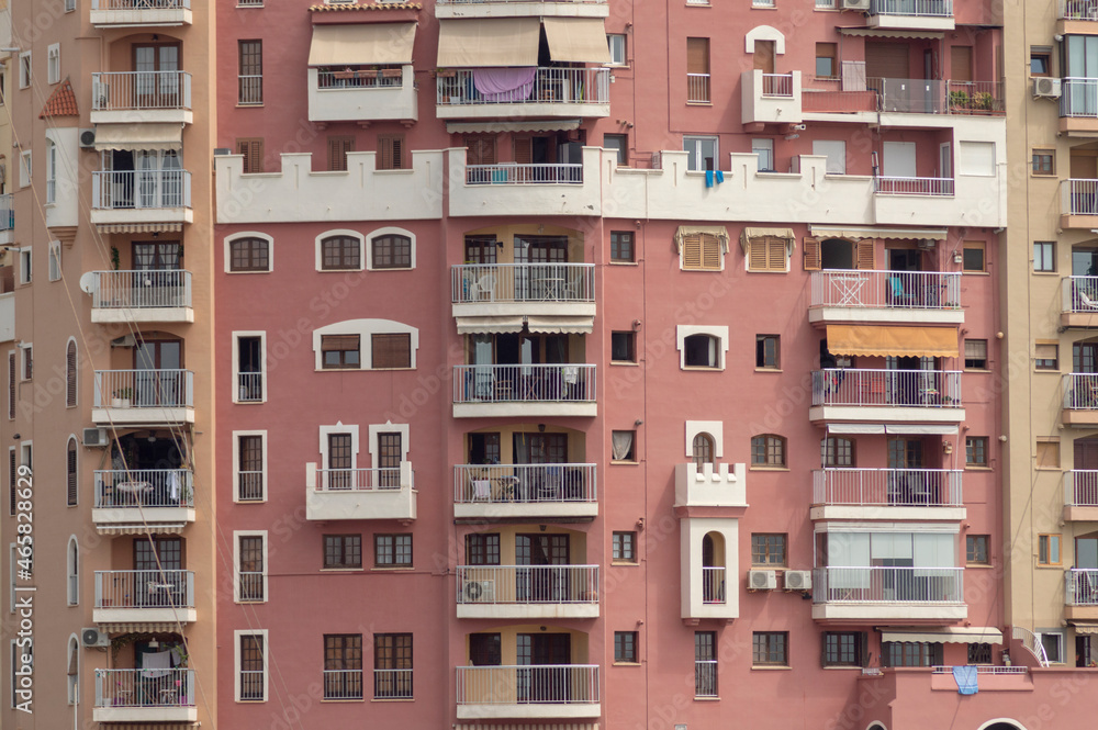 facade of a community with multiple balconies and windows of different sizes