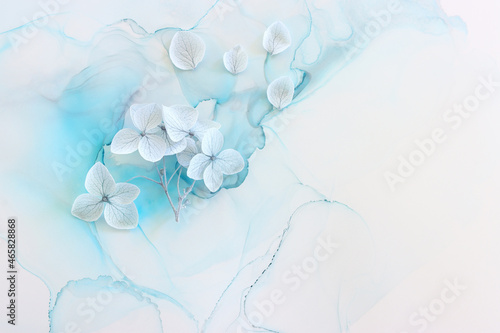 Creative image of pastel blue Hydrangea flowers on artistic ink background. Top view with copy space