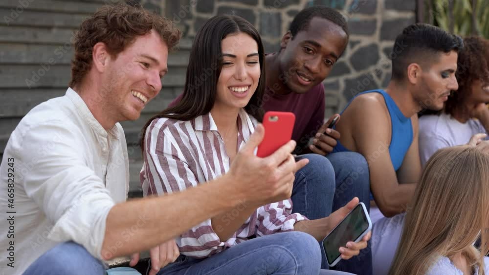 Multiracial young friends enjoy day in the city while using mobile phone - Diverse millennial people and friendship concept
Multiracial young friends enjoy day in the city while using mobile phone - Diverse millennial people and friendship concept