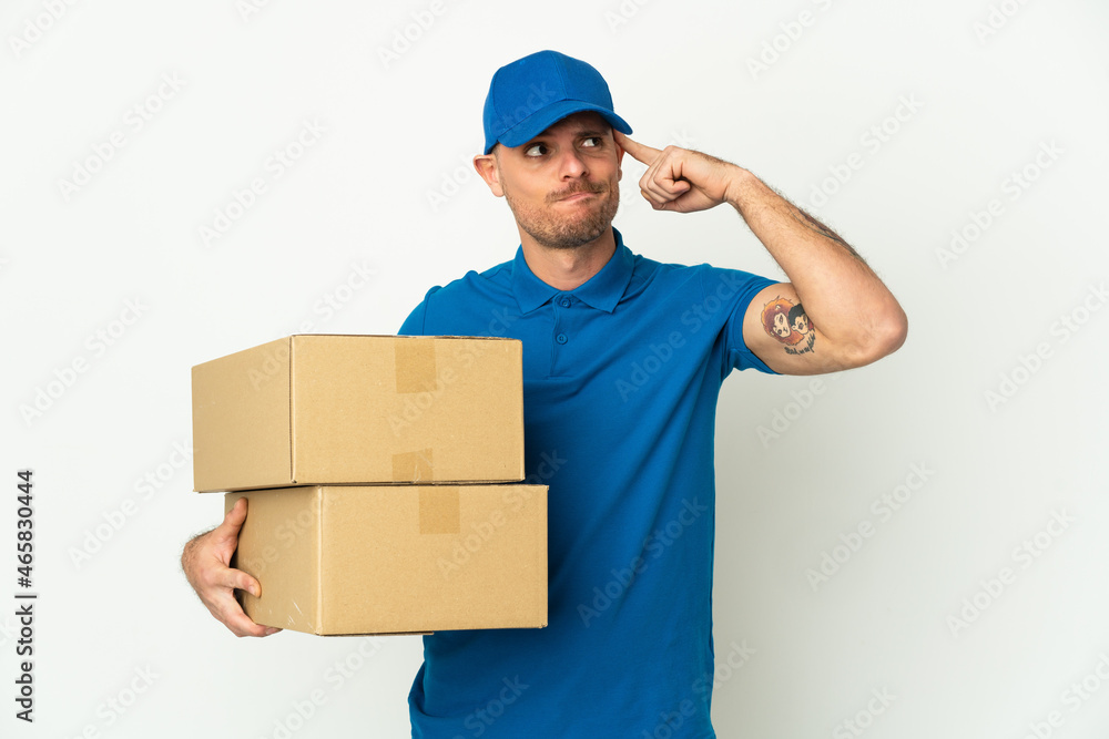 Delivery caucasian man isolated on white background having doubts and thinking Delivery caucasian man isolated on white background having doubts and thinking