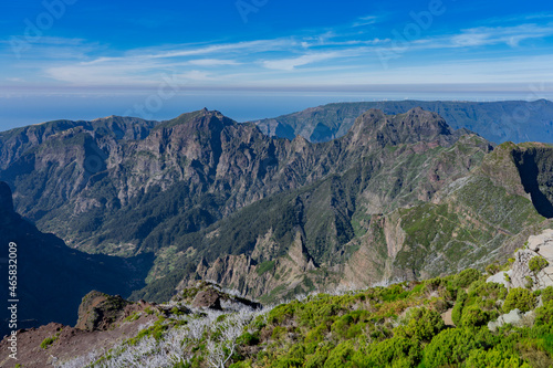 View of Atlantic ocean, rocks, hills and mountains from Pico Ruivo (PR1.3 Vereda da Encumeada, Madeira, Portugal) during sunny day. 