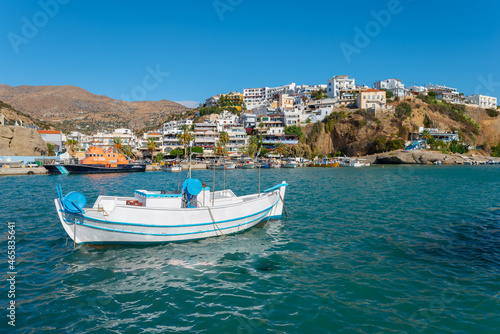View across the harbor to the promenade and the fishing boats of the popular resort of Agia Galini on the south coast of Crete. The village was already settled in the times of the Minoan culture