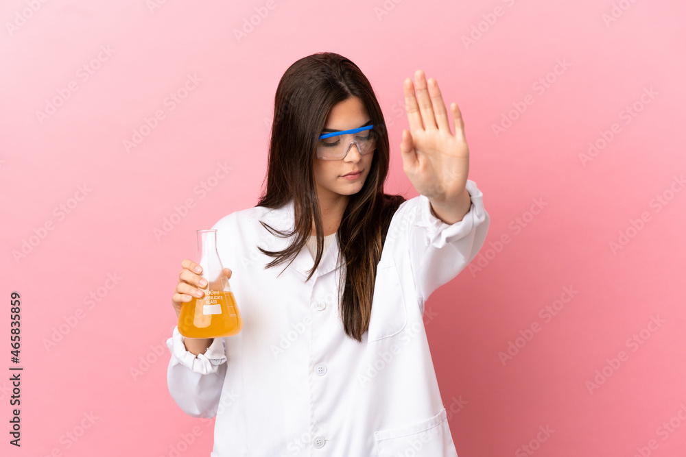 Young scientific girl over isolated pink background making stop gesture and disappointed Young scientific girl over isolated pink background making stop gesture and disappointed