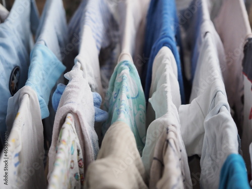 Canvas Print purely washed baby clothes for a newborn, hung on the dryer