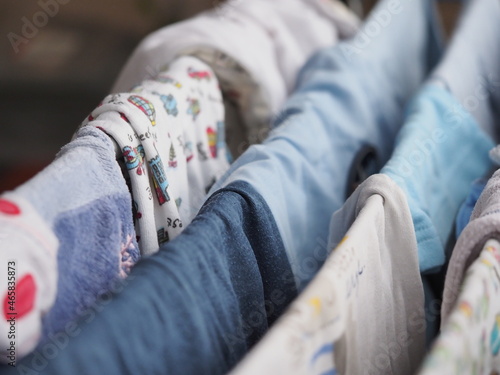 фотографія purely washed baby clothes for a newborn, hung on the dryer