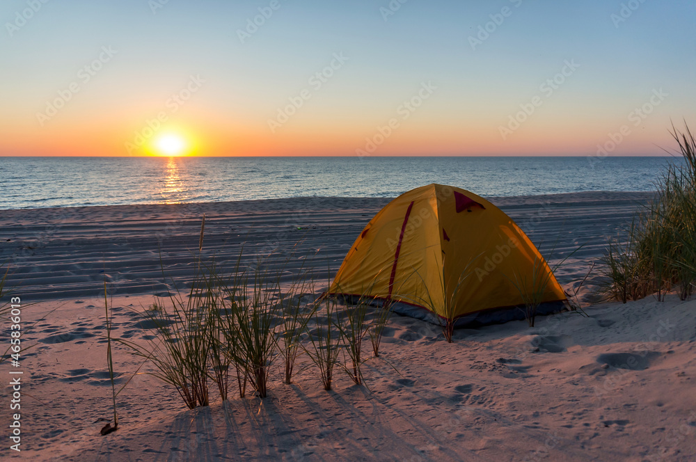 Yellow tent on the sea sand. Tent on the beach. Baltic coast.