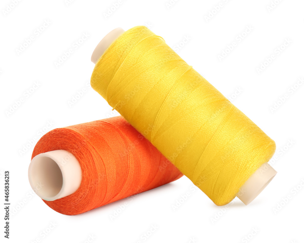 Different colorful sewing threads on white background, closeup Different colorful sewing threads on white background, closeup