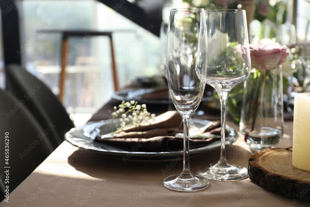 Fototapeta premium Festive table setting with beautiful tableware and floral decor in restaurant