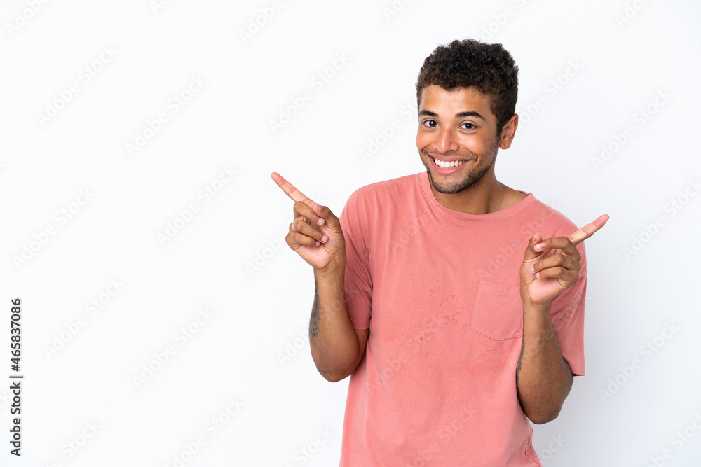 Young handsome Brazilian man isolated on white background pointing finger to the laterals and happy Young handsome Brazilian man isolated on white background pointing finger to the laterals and happy