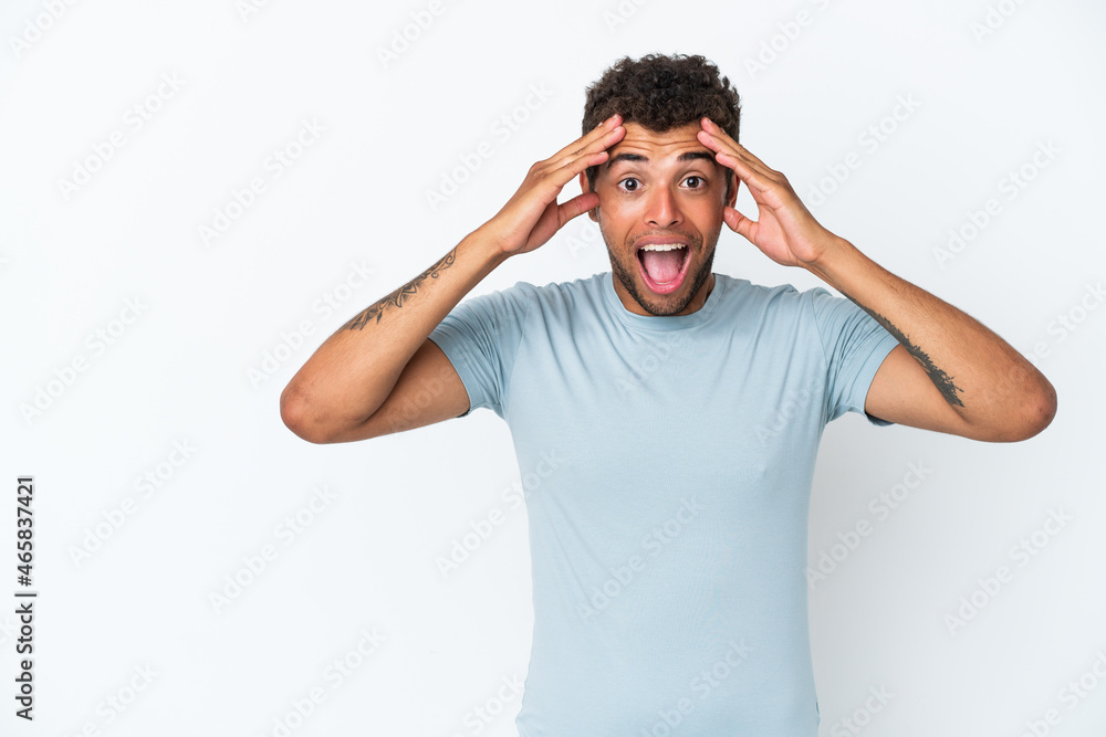 Naklejka premium Young handsome Brazilian man isolated on white background with surprise expression