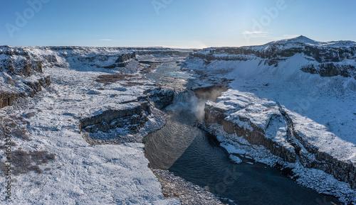 Hafragilsfoss waterfall with snow in autumn aerial view, Iceland. photo