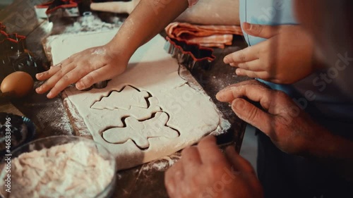 Grandfather and his cute little granddaughter prepare Christmas cookies. Close up of hands
