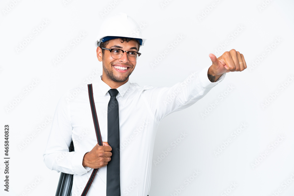 Architect brazilian man with helmet and holding blueprints giving a thumbs up gesture Architect brazilian man with helmet and holding blueprints giving a thumbs up gesture