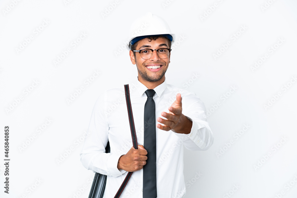 Architect brazilian man with helmet and holding blueprints shaking hands for closing a good deal Architect brazilian man with helmet and holding blueprints shaking hands for closing a good deal