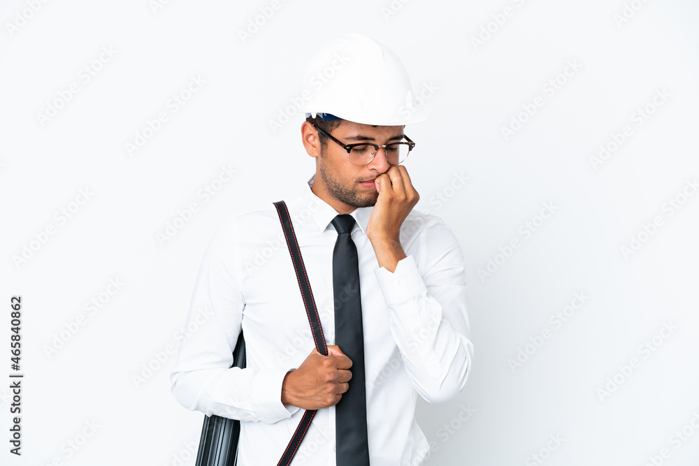 Architect brazilian man with helmet and holding blueprints having doubts Architect brazilian man with helmet and holding blueprints having doubts