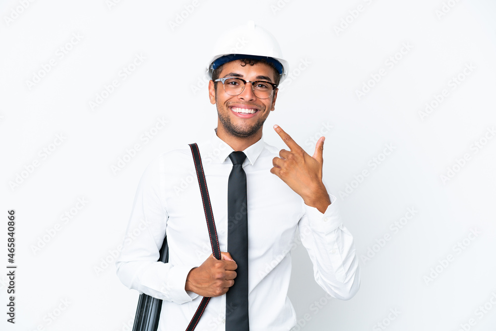 Architect brazilian man with helmet and holding blueprints giving a thumbs up gesture Architect brazilian man with helmet and holding blueprints giving a thumbs up gesture