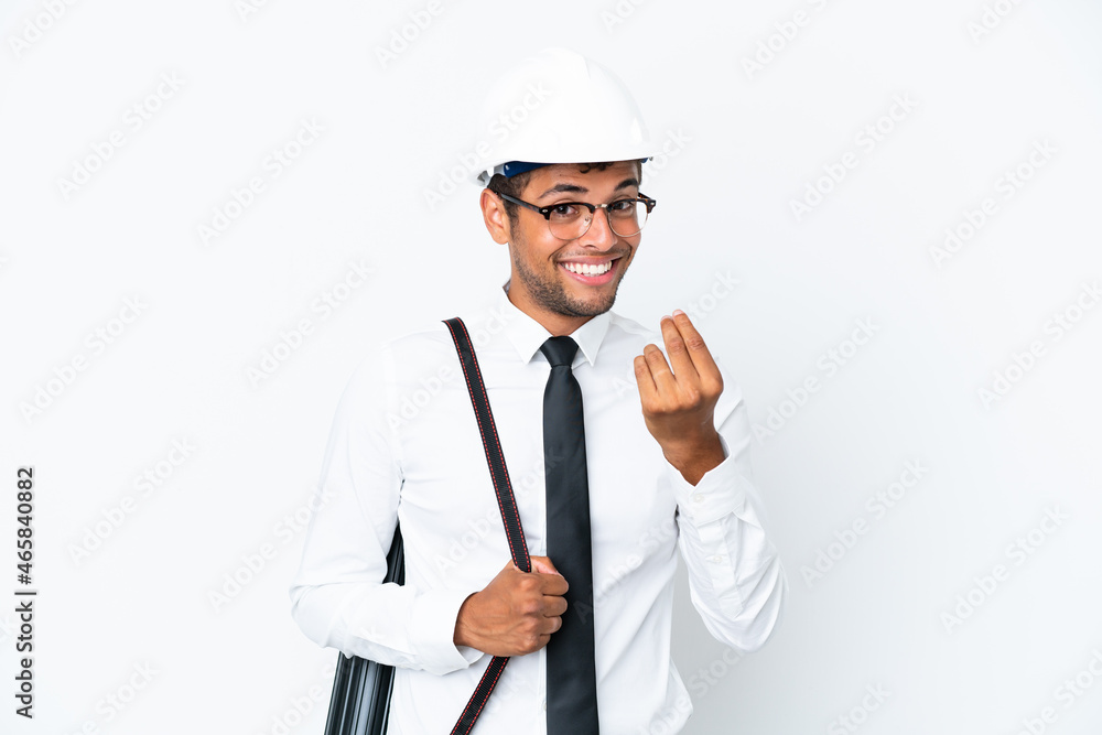 Architect brazilian man with helmet and holding blueprints making money gesture Architect brazilian man with helmet and holding blueprints making money gesture