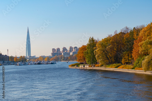 Saint-Petersburg. Russia. View of the city from the autumn park from the embankment of the Lakhtinsky spill. Modern architecture of St. Petersburg. Horizontal frame.