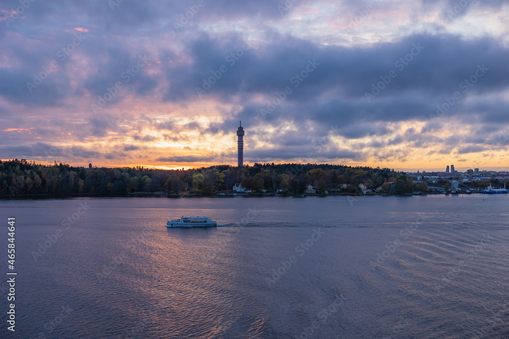 Stockholm, Sweden - Oct 14th 2021: Stockholm Baltic Sea bay a view from water with Kaknäs tower (Kaknästornet) in the background in autumn sunset