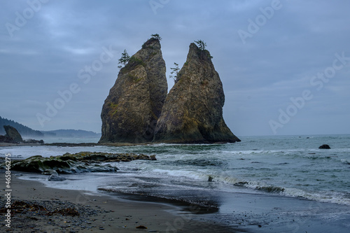 Sibling sea stacks wade in the Rialto Beach waters at Olympic National Park