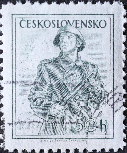 Czechoslovakia Circa 1954: A postage stamp printed in Czechoslovakia showing a portrait of a soldier in a coat, combat suit, steel helmet and machine gun