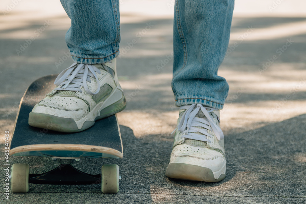 close-up of feet with skateboard