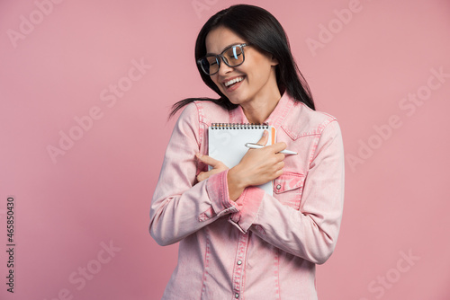 Excited cute woman in glasses smiling broadly indoors