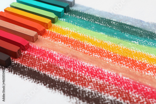 Colorful pastel chalks on white background, closeup. Drawing materials © New Africa