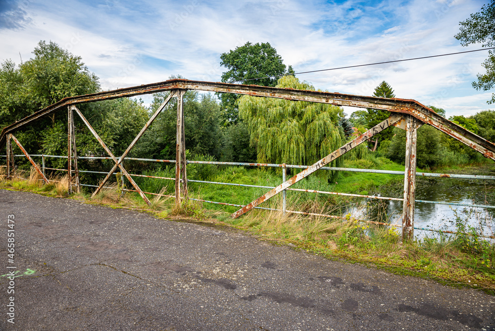 Old broken bridge over river Barycz in village Osetno in Poland Old broken bridge over river Barycz in village Osetno in Poland