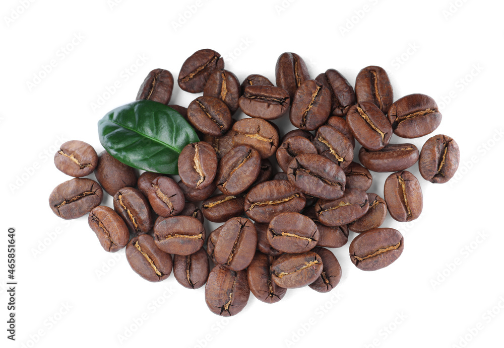 Pile of roasted coffee beans with fresh leaf on white background, top view Pile of roasted coffee beans with fresh leaf on white background, top view